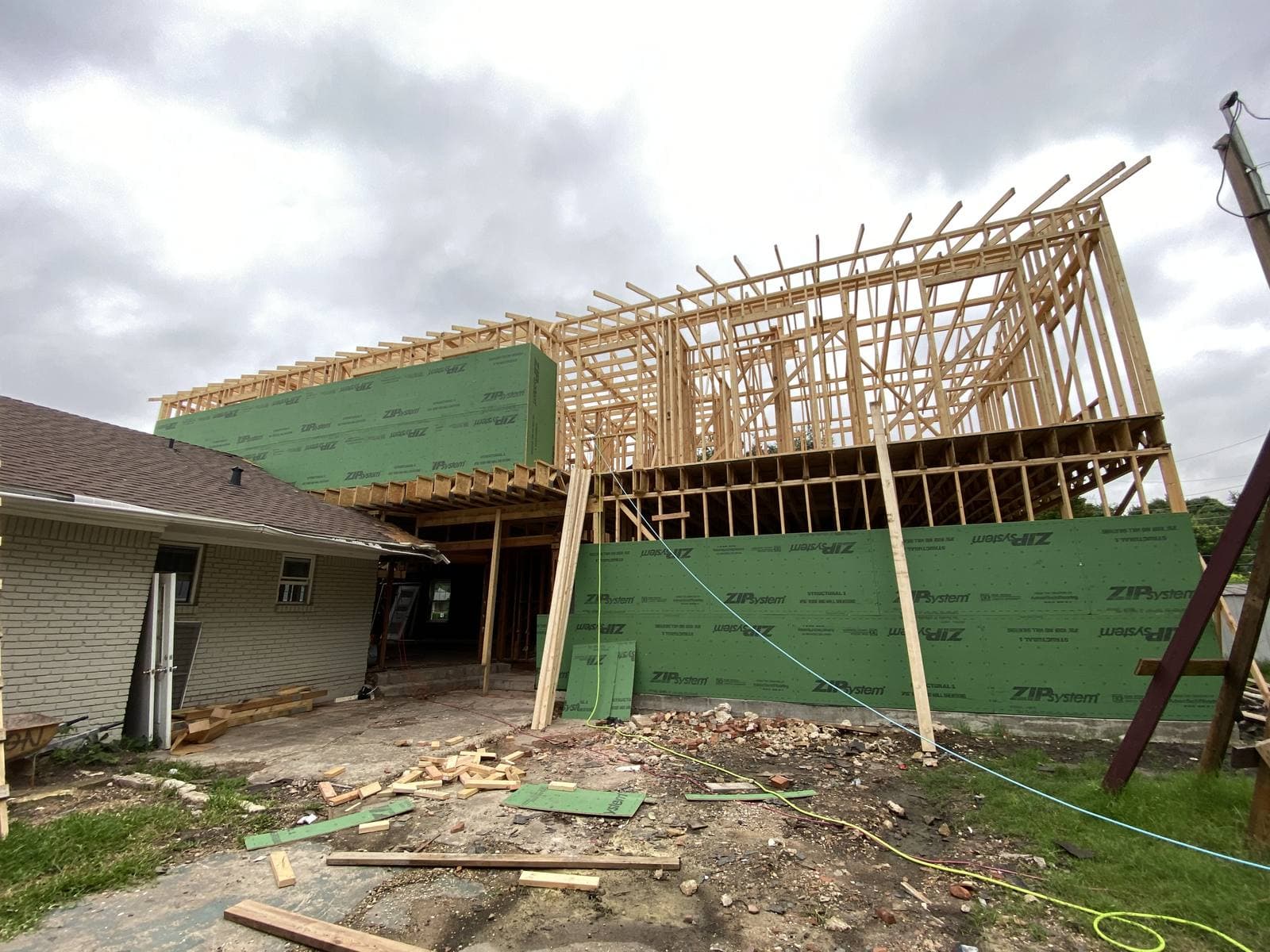 Second-story addition framed and partly sheathed above an existing home